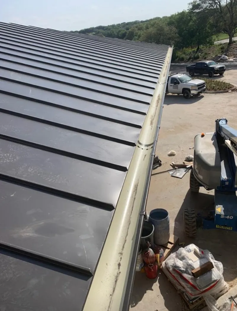 Standing seam panel and gutter detail on a metal roofing jobsite in Ranchettes